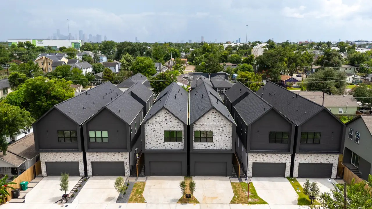 Completed Sohana Homes development in Independence Heights, Houston, with the downtown skyline beyond